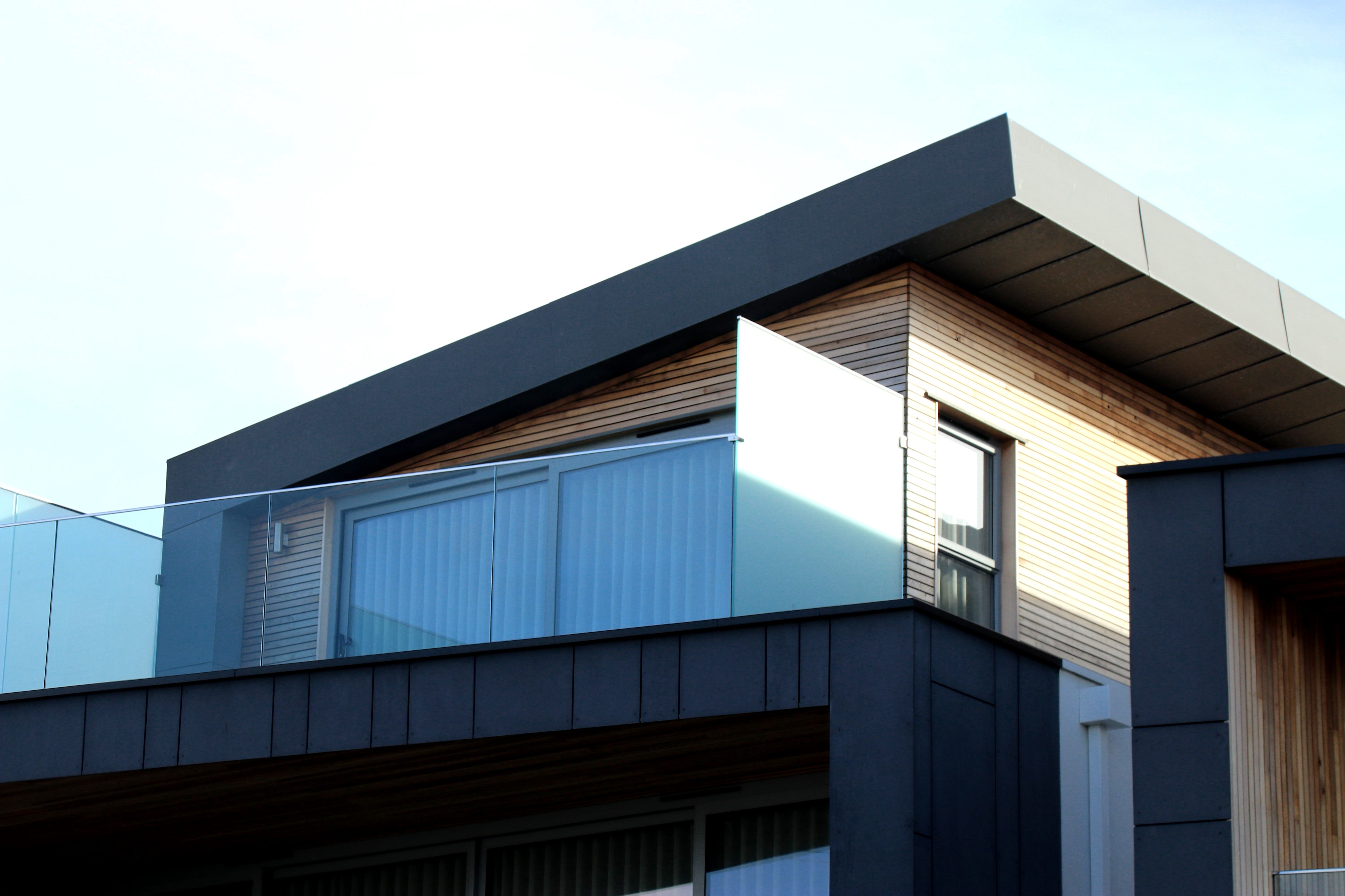 Modern timber clad home with glazed balcony